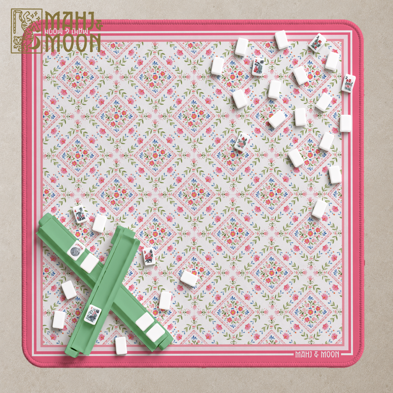 Pink and green floral American Mahjong mat with vintage-inspired diamond pattern, cream background and raspberry pink border.