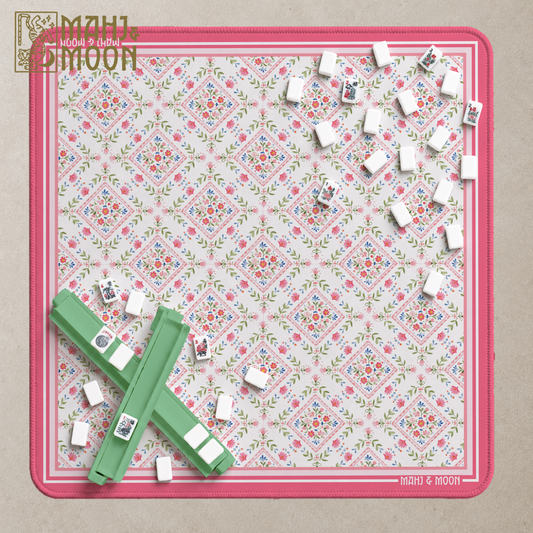 Pink and green floral American Mahjong mat with vintage-inspired diamond pattern, cream background and raspberry pink border.
