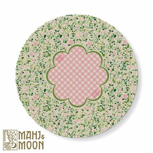 Round American Mahjong mat featuring delicate green leafy vines, blush pink flowers and a pink gingham scalloped centre bordered in green for a charming cottage-inspired game table.