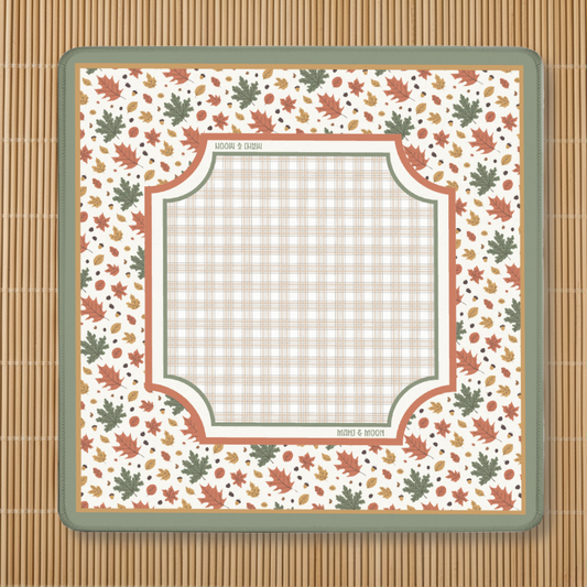 Autumn-themed American Mahjong mat with a falling leaves border, acorns, and a neutral plaid playing centre on a cream background.