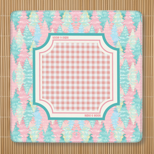 Pastel Christmas Tree American Mahjong mat featuring blush pink and aqua Christmas trees with a pink gingham playing area, premium stitched edges, and non-slip rubber backing.
