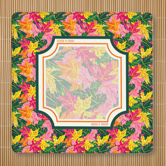 Autumn Leaves American Mahjong mat featuring colourful maple leaves in pink, orange, yellow and green with a coordinating foliage playing area, stitched edges, and non-slip rubber backing.