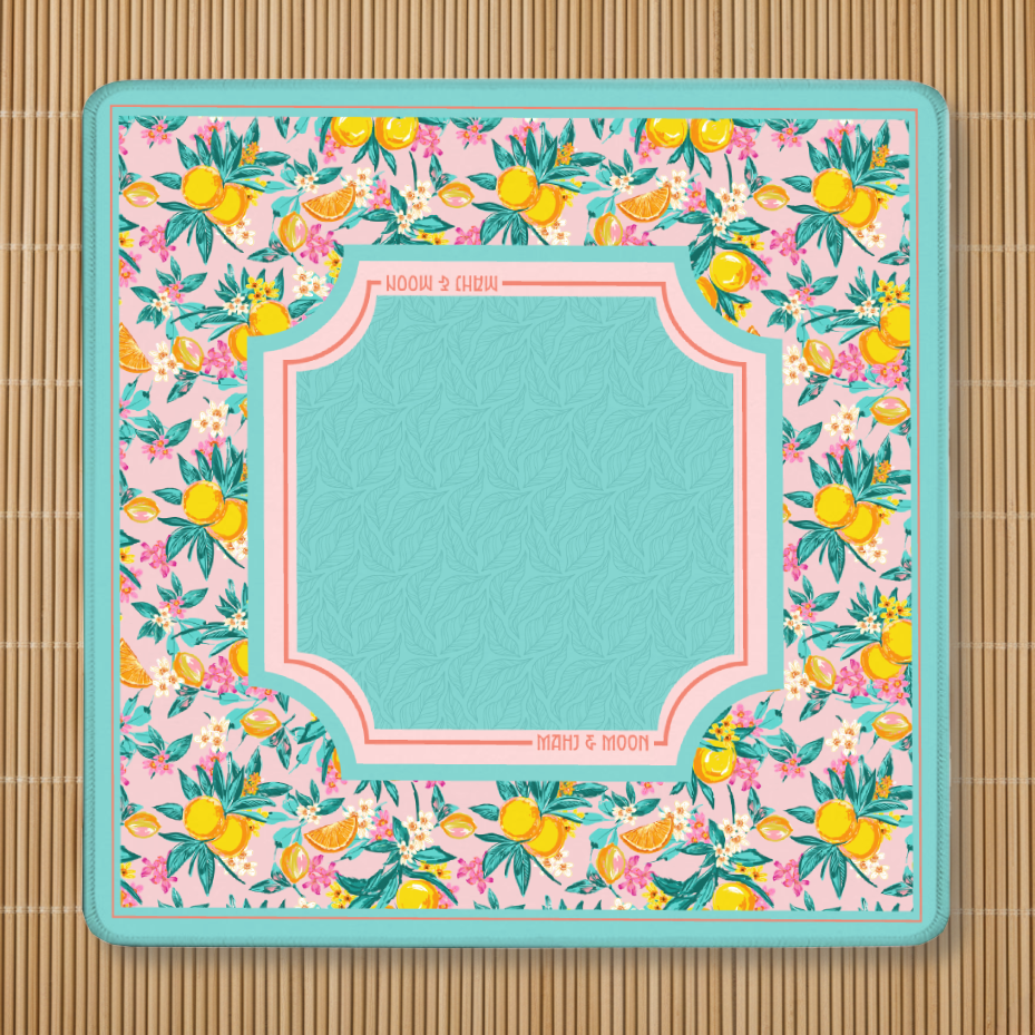 Floral patterned lemon Mahjong pad with a central square area on a bamboo mat background
