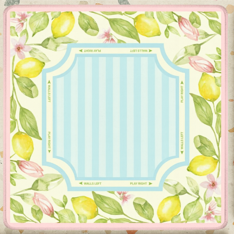 Floral and lemon design mahjong mat with pink borders on a patterned background